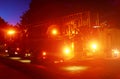 Fire truck with flashing emergency warning lights response scene on a street at night Royalty Free Stock Photo