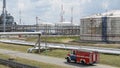 Fire truck in industrial plant. A large red fire rescue vehicle in the chemistry refinary plant