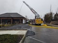 Fire truck uses its aerial hose to fight a devastating fire in a building housing a Starbucks store