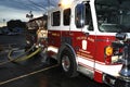 A fire truck has hoses attached at a building fire