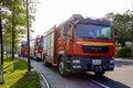 Fire trucks parked on the sidewalk.