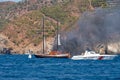 Fire on Turkish yacht in the Mediterranean Sea. Coast guard boat came to the rescue. Oludeniz,Fethiye,Mugla,Turkey