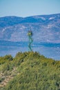 Fire vigilance tower over the hill with mountains in the background