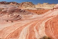 Fire wave with swirly layers of deposited sandstone during wonderful sunny day with blue sky, in Valley of Fire State Park Royalty Free Stock Photo