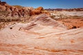 Fire wave with swirly layers of deposited sandstone during wonderful sunny day with blue sky, in Valley of Fire State Park Royalty Free Stock Photo