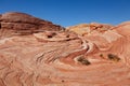 Fire wave with swirly layers of deposited sandstone during wonderful sunny day with blue sky, in Valley of Fire State Park Royalty Free Stock Photo