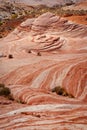 Fire wave with swirly layers of deposited sandstone during wonderful sunny day with blue sky, in Valley of Fire State Park Royalty Free Stock Photo