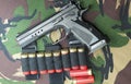 Firearm Pistol on military camouflage background Royalty Free Stock Photo