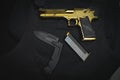 Firearms and bladed weapons. Desert Eagle pistol and large folding tactical knife