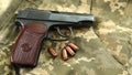 Firearms on military uniform. Top view of a gun with bullets. Military weapons of the USSR.