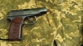 Firearms on military uniform. Top view of a gun with bullets. Military weapons of the USSR.