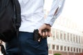 Firearms at school. A teenager with a gun on the background of the school. A man goes to school with a gun. School violence Royalty Free Stock Photo