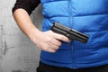 Firearms for self-defense. Black pistol in male hand