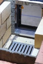 Fireclay masonry of the firebox. Grate and firebox door. Construction of a heating stove Royalty Free Stock Photo