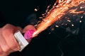 Firecracker Burning in Hand with Sparks and Smoke Royalty Free Stock Photo