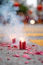 Firecrackers exploding on a street during lunar celebration, surrounded by colorful debris, creating a festive Royalty Free Stock Photo