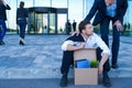 Fired businessman sitting on street Royalty Free Stock Photo