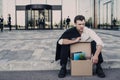 Fired businessman sitting on street Royalty Free Stock Photo