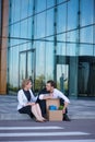 Fired businessman sitting on street Royalty Free Stock Photo