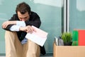 Fired businessman reading the notice of job termination Royalty Free Stock Photo