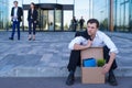 Fired businessman sitting on street Royalty Free Stock Photo