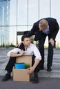 Fired businessman sitting on street Royalty Free Stock Photo