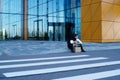 Fired businessman sitting on street Royalty Free Stock Photo