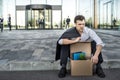 Fired businessman sitting on street Royalty Free Stock Photo