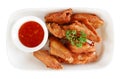 Fired chicken wings with sauce in ceramic plate top view isolated on white background, path