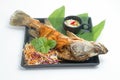 Fired fish with fishsauce and mango salad Royalty Free Stock Photo