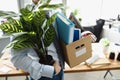 A fired man carries personal belongings in a box Royalty Free Stock Photo