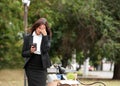 Fired office worker with personal stuff and coffee in park