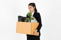 Fired unemployed young Asian business woman in suit holding box with personal belongings on white isolated background.