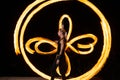 firedancer. Sexy woman perform fire tricks in darkness. Fire performance. Burning poi spinning.