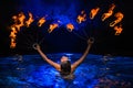 Firedancer woman in water Royalty Free Stock Photo