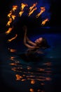 Firedancer woman in water Royalty Free Stock Photo