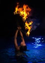 Firedancer woman in water Royalty Free Stock Photo