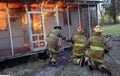 Firefighers fighting a house fire with flames Royalty Free Stock Photo