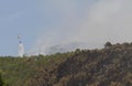 Firefight helicopter dropping water over fire on a forest