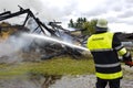 Firefighter in action at burning house