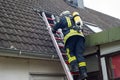 Firefighter in action and extinguish apartment fire - Serie Firefighter Royalty Free Stock Photo