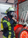 Firefighter in action and with oxygen bottle and mask - Serie Firefighter Royalty Free Stock Photo