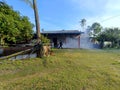 Firefighter in Action: Responding to a House Fire in a Rural Setting Royalty Free Stock Photo