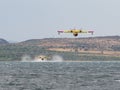 Firefighter airplane, water bomber, air tank taking water from t