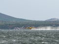 Firefighter airplane, water bomber, air tank taking water from t