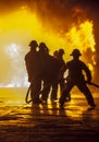 Firefighter bracing during firefighting Royalty Free Stock Photo