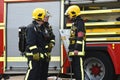 Firefighters in breathing gear are briefed