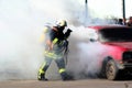 Firefighter and burning car Royalty Free Stock Photo