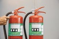 Firefighter are checking fire extinguishers tank in the building Royalty Free Stock Photo