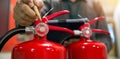 Firefighter are checking fire extinguishers tank in the building concepts of prevention safety training Royalty Free Stock Photo